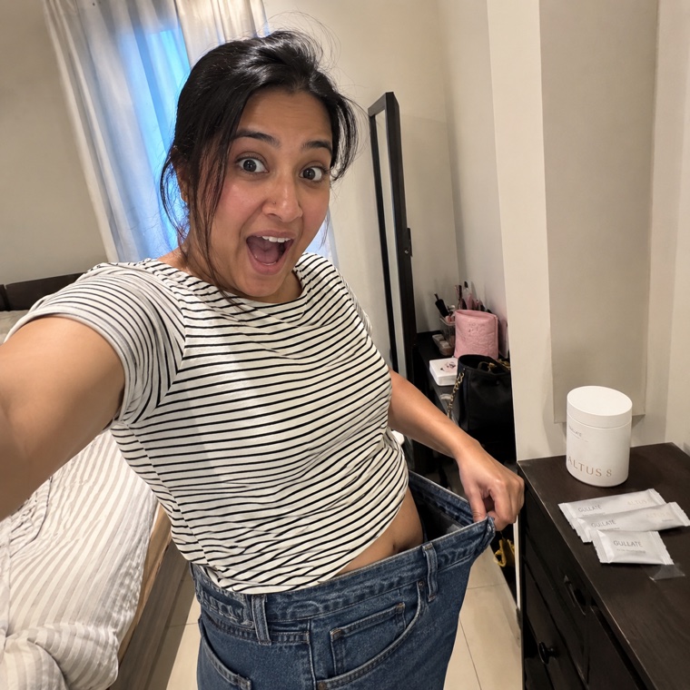 ALTUS 8 member Thillagam holding out her loose old jeans